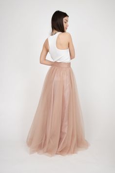 "This elegant skirt is crafted from 6 meters of structured tulle and has a slub trim that flatteringly accentuates your waist. It is lined with matching satin layer. Wear it to emphasize movements as you are walking down the streets, or style it away from the everyday life to add volume under feminine dresses. Brilliant choice for your dream wedding .. <3 Team yours with flats or heels and live through yours fairy tale. MATERIALS: -tulle, satin lining --------------------------------- If you Long Summer Party Skirt, Summer Party Long Skirt, Evening Flared Skirt For Summer, Elegant Voluminous Mini Skirt, Summer Evening Flared Skirt, Summer Evening Skirt, Summer Long Tulle Pleated Skirt, Voluminous Skirt For Summer Parties, Elegant Pleated Skirt Petticoat For Summer