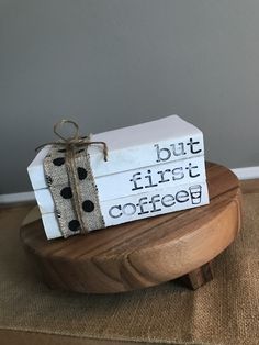 two wooden boxes with black and white polka dots tied to them sitting on a wood stand