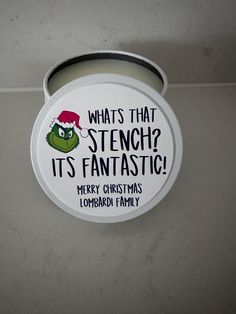 a round tin can with the grin face on it's lid that says, whats that stenchp its fantastic merry christmas lompard family