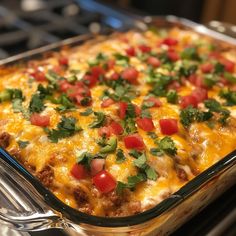 a casserole dish with tomatoes, cheese and cilantro