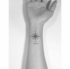 a small compass tattoo on the wrist