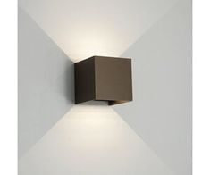 a square light fixture mounted to the side of a wall