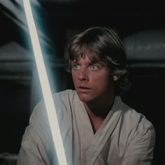 luke star wars the force awakes with his lightsaber in front of him