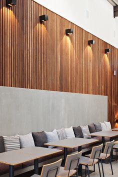 an empty restaurant with tables and chairs lined up against the wall next to each other