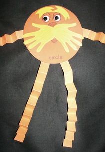 an orange paper plate with a face and arms made to look like a human body