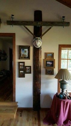 a living room with a cross on the wall and pictures on the walls above it