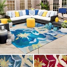 an outdoor living room with colorful rugs and pillows on the floor, including a sectional couch