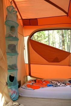 the inside of a tent with a bed in it