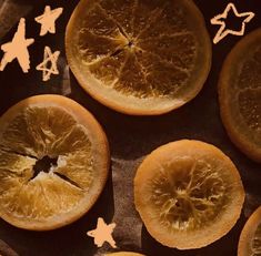 an orange cut in half on top of a piece of paper with stars around it