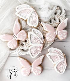 some pink and white cookies with butterflies on them