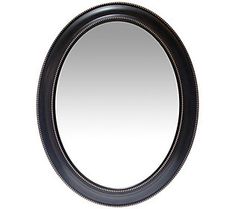 a black oval mirror on a white background