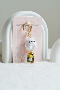 a keychain with a small white sheep on it