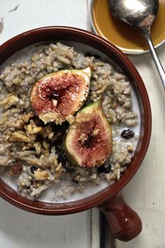 a bowl filled with oatmeal topped with figs