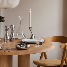 a wooden table with silverware and candles on it