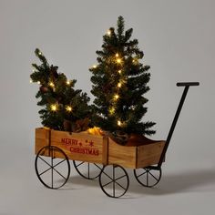 Add a traditional accent to your holiday decor with this 3-Piece LED Pre-Lit Artificial Christmas Tree Set with Wagon from Wondershop™. Standing on black wheels, the classic holiday figurine has a brown wood-finish cart that showcases the greeting "Merry Christmas" in bold red typography with red snowflakes and dots for a welcoming look. It carries two green Christmas trees that are nestled in burlap-sack bases and strung with LED bulbs to brighten up the look with seasonal sparkle. Keep it solo Porch Christmas Decorations, Christmas Tree Outfit, Blue Magnolia, Red Typography, Red Snowflakes, Lantern Christmas, Christmas Tree Set, Christmas Porch Decor, Merry Christmas Greetings