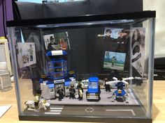 a display case filled with legos on top of a wooden table