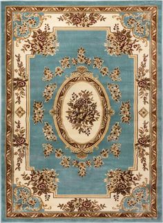 a blue rug with gold trimmings and an ornate design on the center piece