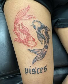 a woman with a tattoo on her leg that says pisces and two koi fish