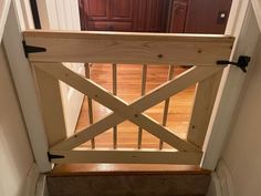 an open wooden gate on the stairs leading to a door