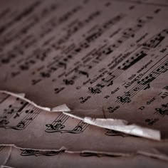 an old sheet of music paper with musical notes on it's edges and torn off