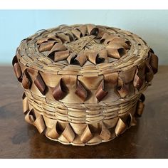 a wooden basket sitting on top of a table