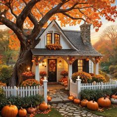 a painting of a house with pumpkins around it