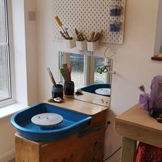 a bathroom with a sink, mirror and other items on the counter in front of it