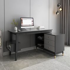 a desk with a computer on top of it next to a plant and a framed photograph