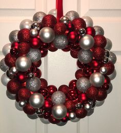 a red and silver christmas ornament wreath