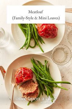 meatloaf, green beans and tomato sauce on two white plates with silverware