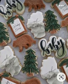 decorated cookies with trees, bears and names on them are displayed for the guests to eat