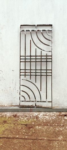 a white wall with a metal structure on it