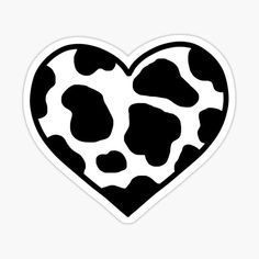 a heart shaped sticker with black and white cow print on the inside of it