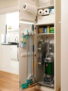 an open cabinet in the middle of a kitchen with cleaning supplies and toiletries inside