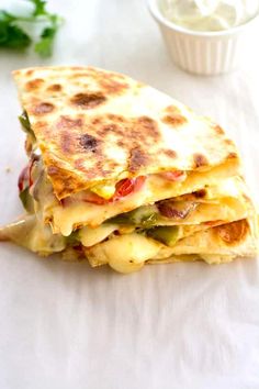 a stack of quesadillas sitting on top of a white table