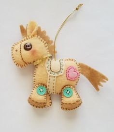 a stuffed toy horse ornament hanging from a string