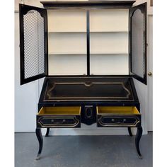 an old fashioned desk with two drawers and a bookcase in the middle, on display