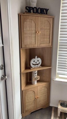 a wooden shelf with two baskets on top of it next to a white door and window