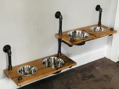 two wooden shelves with metal bowls on them