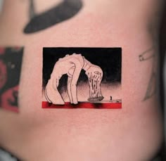 a person with a tattoo on their stomach has an image of a man bending over