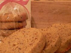 some cookies are sitting on a table next to a bag