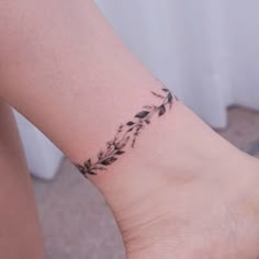 a woman's foot with a small tattoo on the left side of her leg