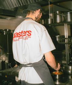 a man standing in a kitchen preparing food