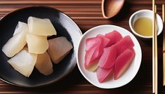 chopsticks and bowls of food on a wooden table