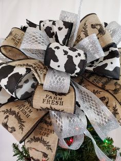 a cow print bow on top of a christmas tree