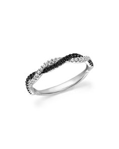 a white gold ring with black and white diamonds