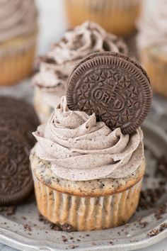 an oreo cookie on top of a cupcake