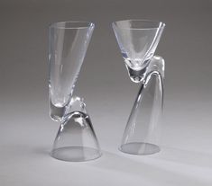 two clear glass vases sitting next to each other