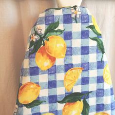 a blue and white checkered apron with lemons on it