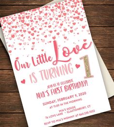 a pink and gold 1st birthday party card with hearts on it, the text is our little love is turning 1